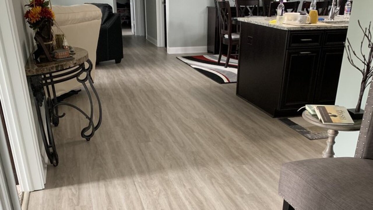 Light luxury vinyl plank flooring in an open kitchen and living area