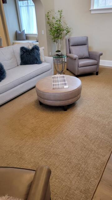 Finished carpet room shown behind the customer review card